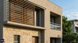 Close-up 3D render of 40x60 G+2 west facade showing horizontal aluminium louvres, stone cladding lower half, and recessed west windows