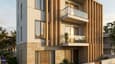 Design highlight of the contemporary east facing elevation of a 60x60 4-floor home with vertical stone fins, glass balcony railings and staggered balconies