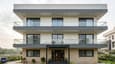 Design highlight of 60x60 north facing 4-floor modern home elevation with horizontal banding and balconies