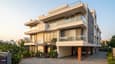 Modern south-facing G+3 home on a 40x50 plot with layered balconies, large glazed facade, and landscaped driveway
