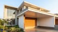 South-facing 25x40 duplex elevation with deep overhang and thermal mass