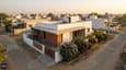Aerial view of 25x50 east-facing single floor home with morning sun, integrated landscape, and shaded entry portico