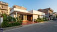 Hero image of a modern 25x40 east-facing single-floor home with morning sunlight illuminating the living room facade