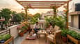 A family enjoying their south-facing second-floor terrace with outdoor seating, potted plants, and a garden pergola