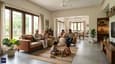 A multigenerational Indian family relaxing in the spacious living room of a north-facing single-story bungalow