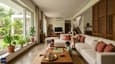 Lifestyle scene — family in the north-facing living room of a 60x60 G+2 home, soft diffused light throughout the afternoon