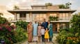 A multi-generational Indian family — grandparents, parents, and children — standing together in front of their completed four-floor south-facing 60x60 home with a lush garden and landscaped entry