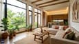 Modern 25x30 south-facing home interior with north-facing living room flooded with soft natural light, comfortable seating, minimalist decor in earth tones, large windows framing views, professional architectural photography, warm and inviting aesthetic
