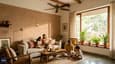 Modern Indian home interior with light-filled living room, ceiling fan, south-facing window with thermal mass wall visible, minimal air conditioning, warm afternoon light, contemporary furnishings, comfortable family gathering space