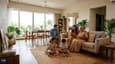 A multigenerational Indian family relaxing in a bright, north-lit spacious living room of a modern single-floor home with large windows and warm interiors