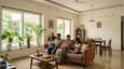Bright airy living room of a 30x40 south-facing ground-floor home at 3 PM — deep overhang filtering direct sun, diffuse warm light filling the 16x13 ft space