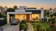 Lifestyle exterior render of a 40x50 north-facing single-floor home at dusk with warm interior glow through large living room windows and landscaped front garden