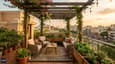 Rooftop terrace lifestyle view on a 40x50 north-facing G+3 home showing south-facing garden, pergola and evening entertaining space with city views