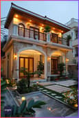Multi-story 30 feet front elevation featuring vertical gardens and living walls for a natural house front wall design