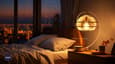 a bed with white sheets and a lamp next to it