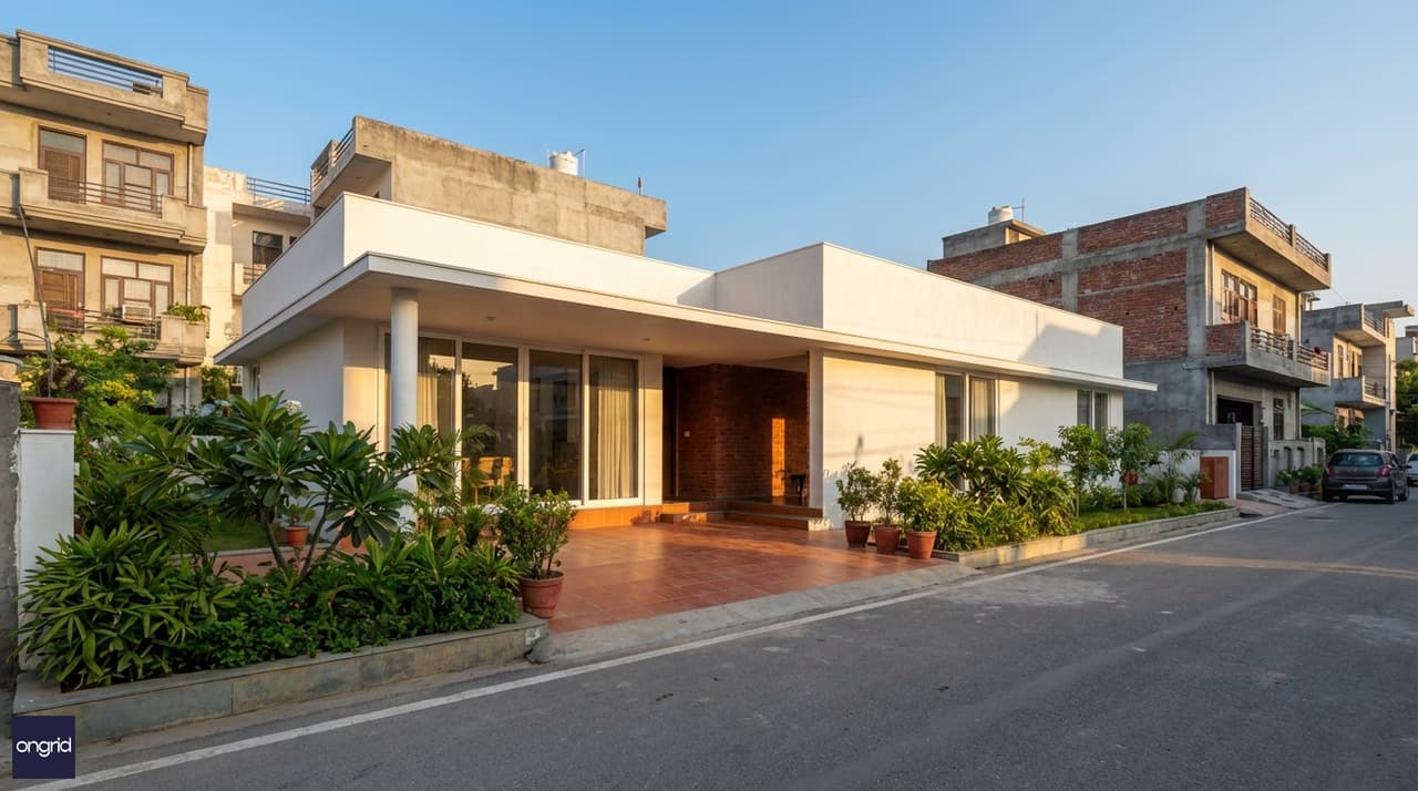 Hero image of a modern 25x40 east-facing single-floor home with morning sunlight illuminating the living room facade