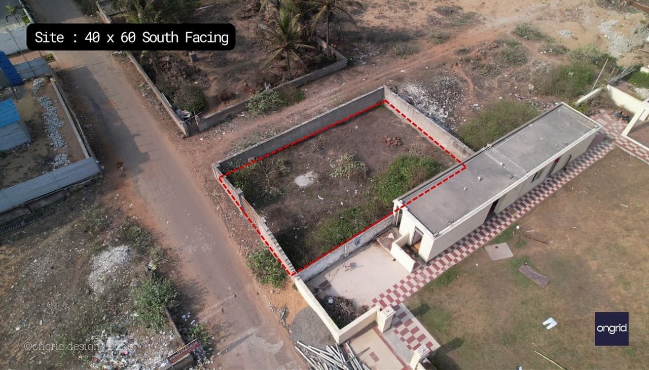 The image shows the beach house site from a bird's eye view. The site is located on a sandy beach, and it is surrounded by palm trees. The beach house is a rectangular structure, and it is located in the center of the site.